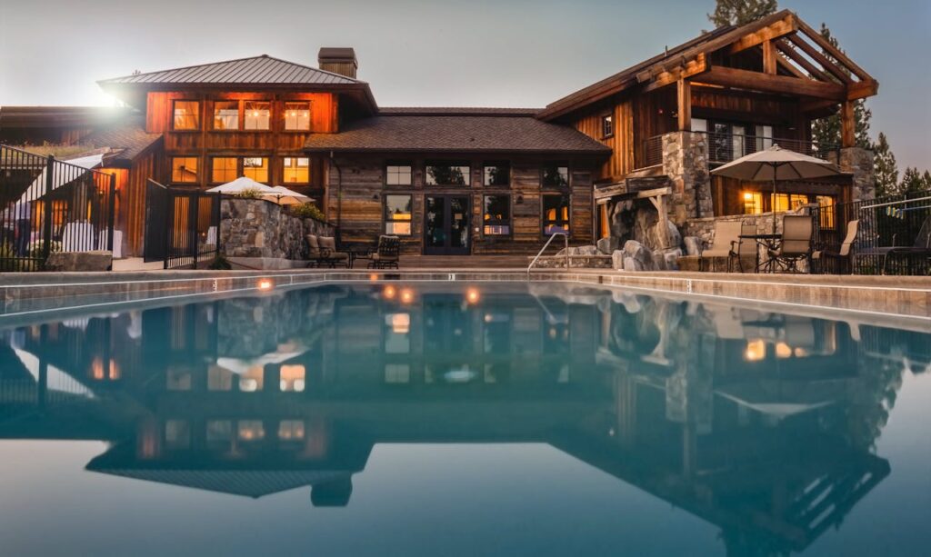 Brown Wooden House Infront of Swimming Pool Under Blue Sky